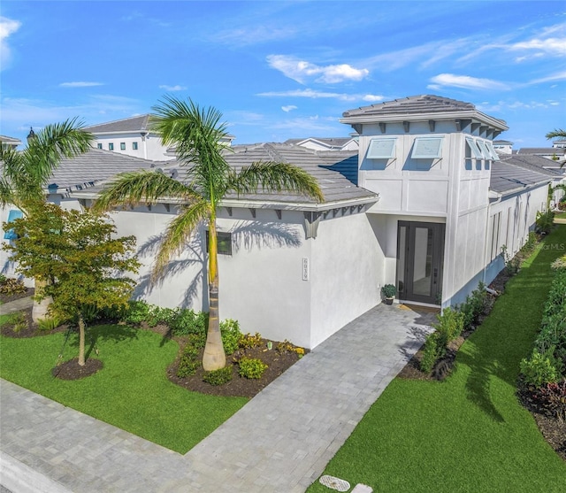 view of front of property with a front yard and stucco siding