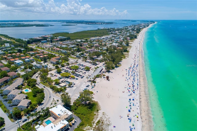 birds eye view of property featuring a water view and a beach view