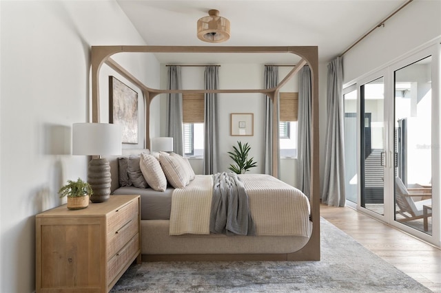 bedroom featuring light wood-type flooring and access to exterior