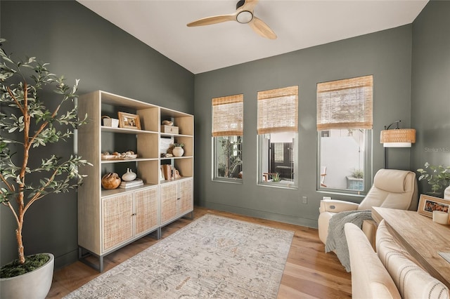 living area featuring ceiling fan and wood finished floors