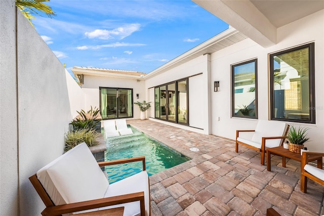 exterior space with stucco siding, a pool, and a patio