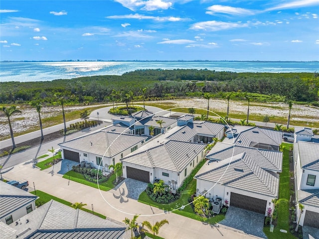 birds eye view of property with a water view and a residential view