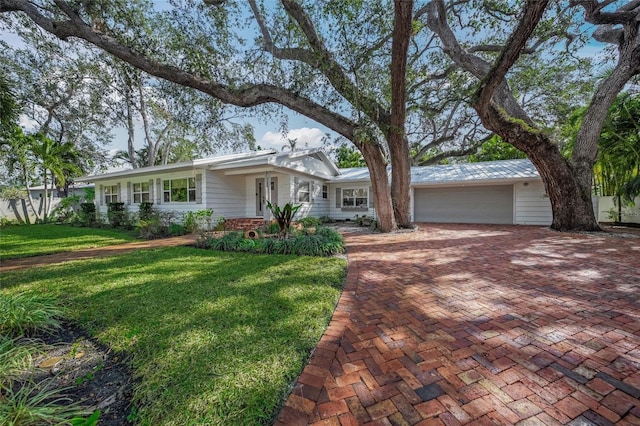 ranch-style house with a garage and a front yard