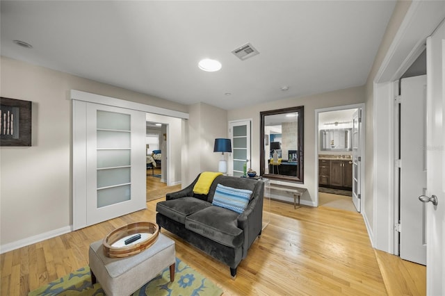 sitting room featuring light hardwood / wood-style floors