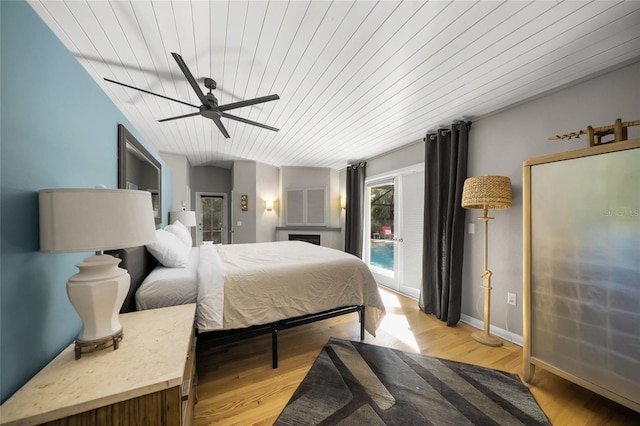 bedroom with wood ceiling, ceiling fan, light hardwood / wood-style flooring, and access to outside