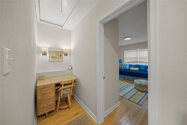 hallway with light hardwood / wood-style floors