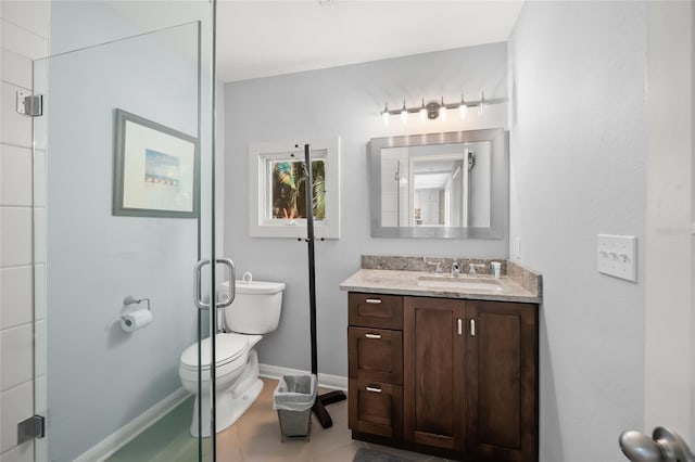 bathroom featuring vanity, toilet, and a shower with door