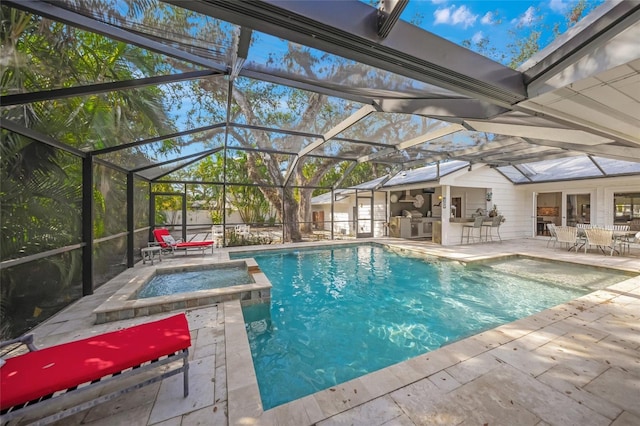 view of pool with an in ground hot tub, a lanai, area for grilling, and a patio area