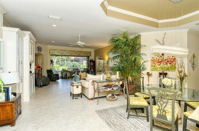 living room featuring crown molding, light tile patterned flooring, and ceiling fan