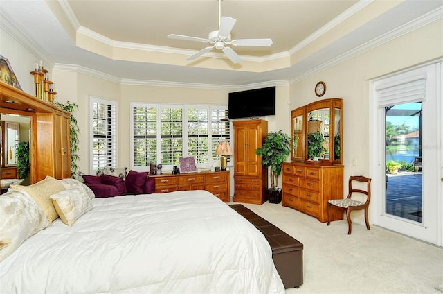 bedroom featuring access to exterior, light colored carpet, a raised ceiling, and ceiling fan