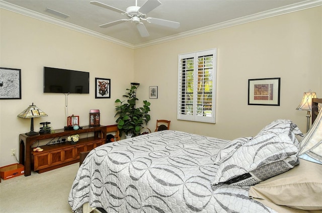 carpeted bedroom with ceiling fan and ornamental molding