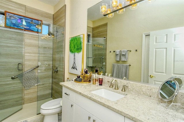 bathroom featuring vanity, toilet, and an enclosed shower