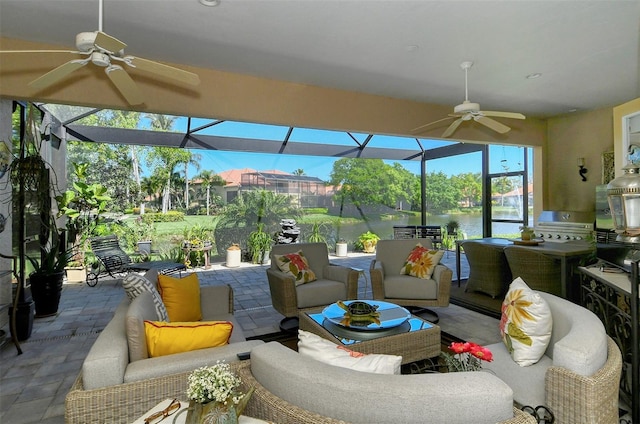 sunroom featuring a water view and ceiling fan