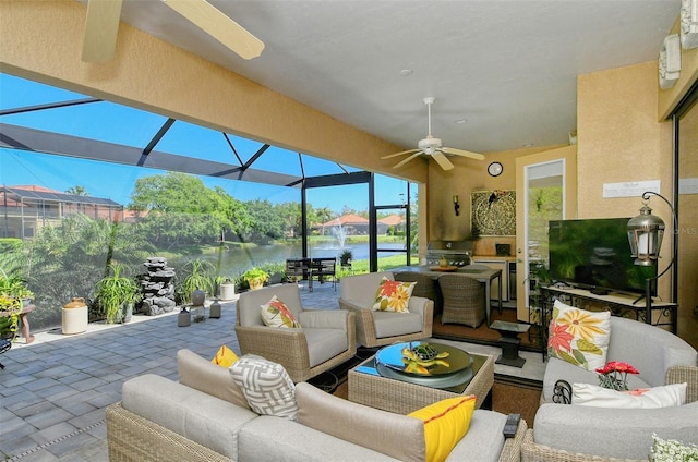 sunroom featuring ceiling fan