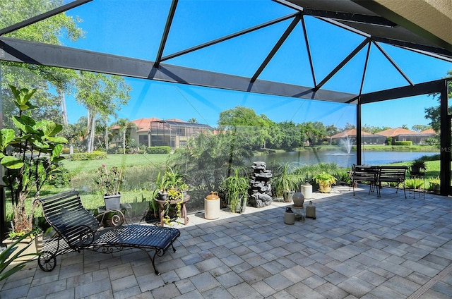 view of patio featuring a water view and glass enclosure