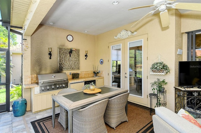 interior space with ceiling fan, a grill, and exterior kitchen