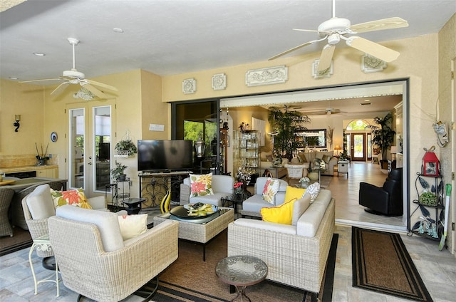 living room with french doors, ceiling fan, and plenty of natural light