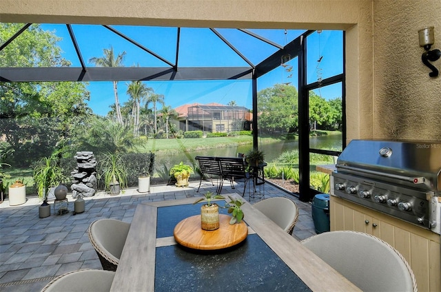 view of patio / terrace featuring area for grilling, a lanai, and a water view