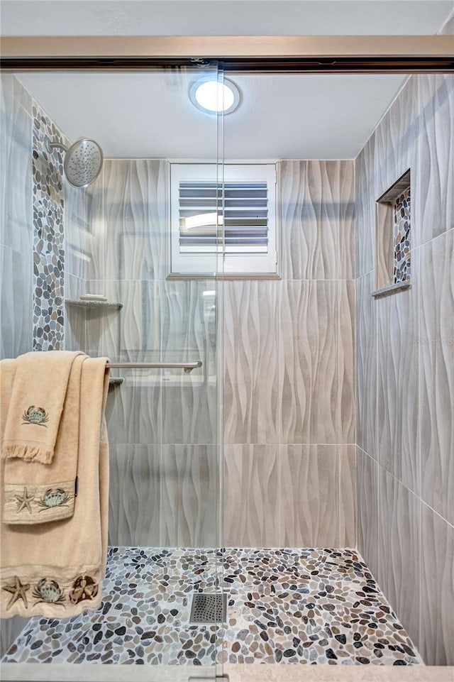 bathroom with tiled shower