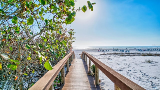 dock area featuring a view of the beach and a water view