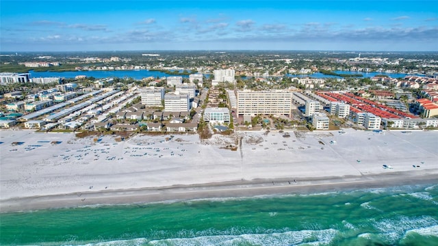 birds eye view of property with a view of the beach and a water view