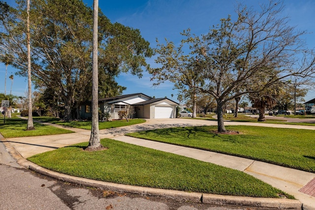 view of front of house with a garage, driveway, and a front lawn