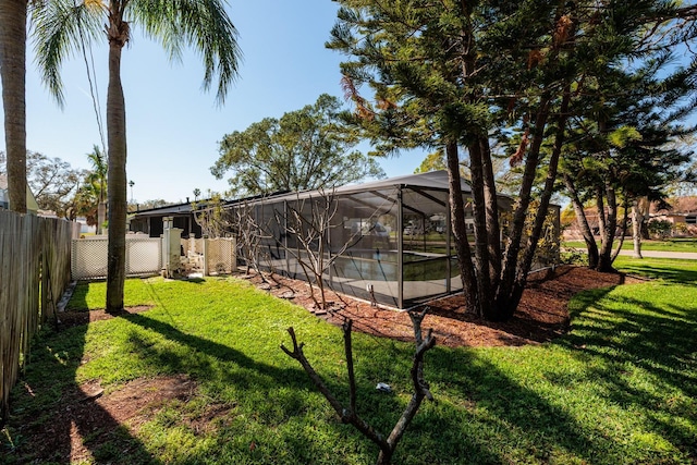 view of yard with a lanai and a fenced backyard