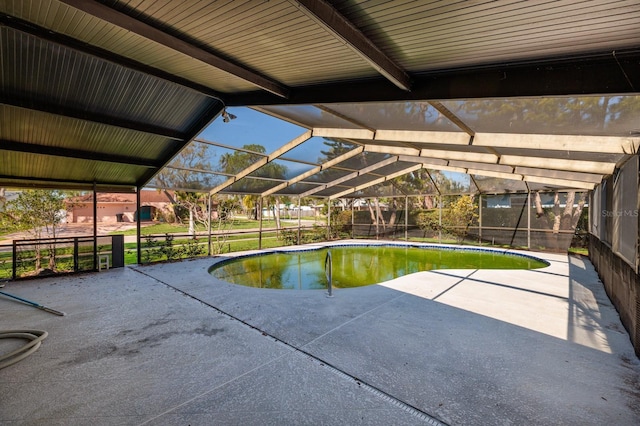 outdoor pool with a lanai and a patio area