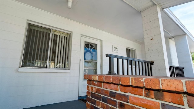 view of exterior entry with a porch