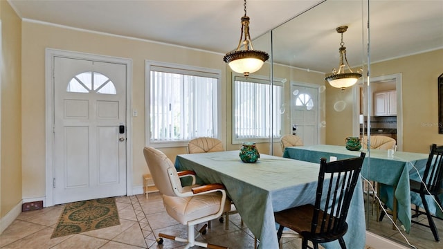 dining room featuring light tile patterned floors and crown molding