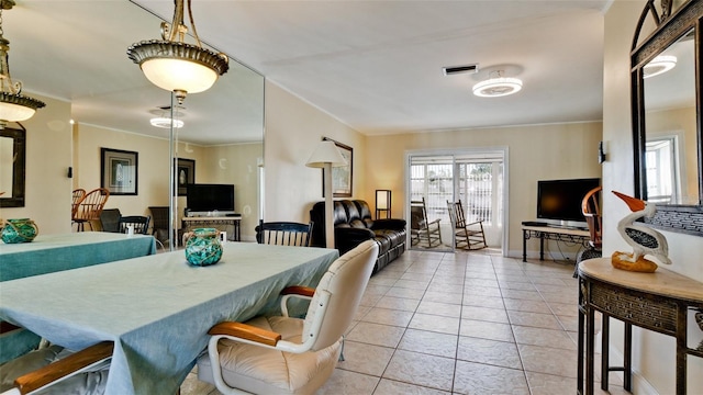 tiled dining area featuring ornamental molding