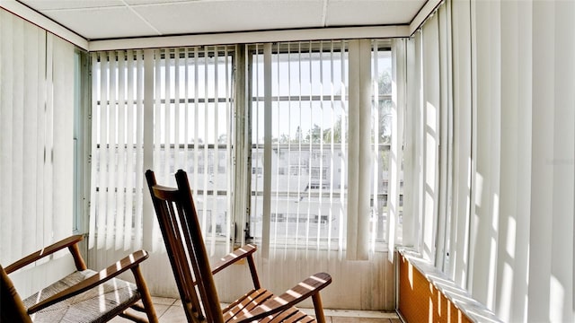 sunroom featuring a paneled ceiling