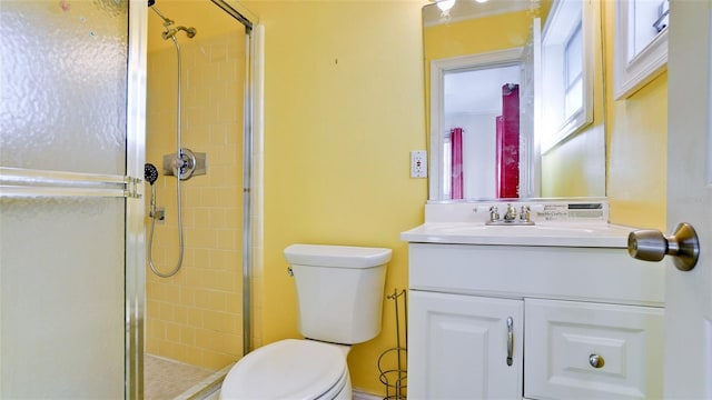 bathroom featuring vanity, toilet, and an enclosed shower