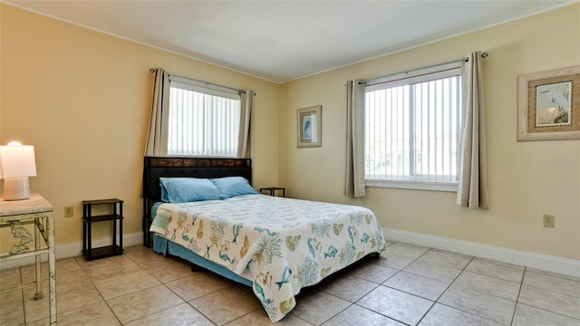 bedroom with light tile patterned flooring and crown molding