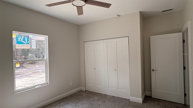 unfurnished bedroom featuring carpet floors, a closet, and ceiling fan