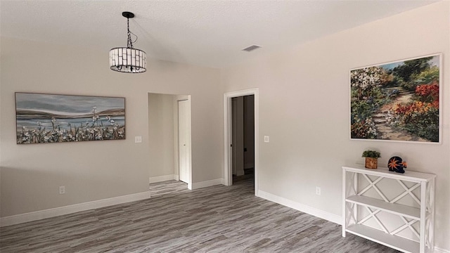 interior space with dark wood-type flooring and a notable chandelier