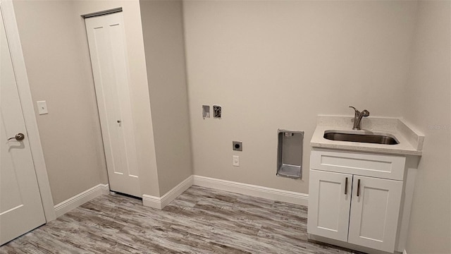 laundry room featuring sink, cabinets, light wood-type flooring, washer hookup, and hookup for an electric dryer