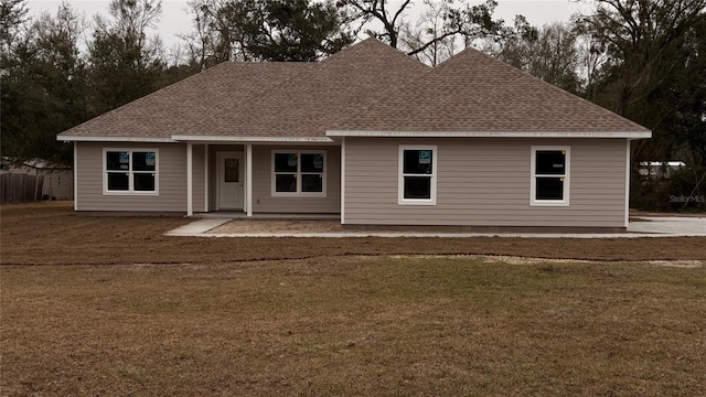 rear view of property with a lawn