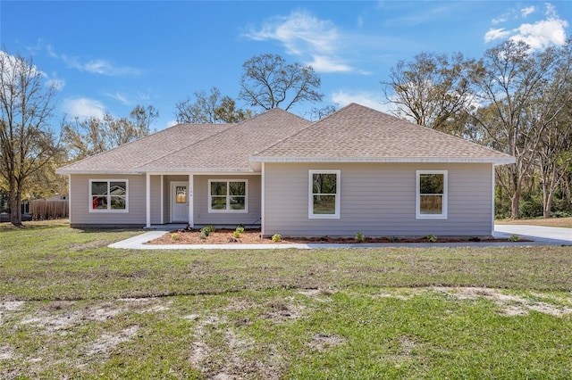 single story home with a front lawn, fence, and a shingled roof