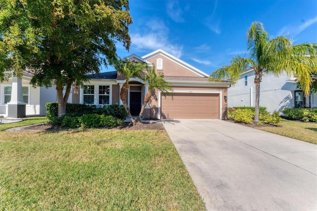 view of front of home featuring a garage and a front yard