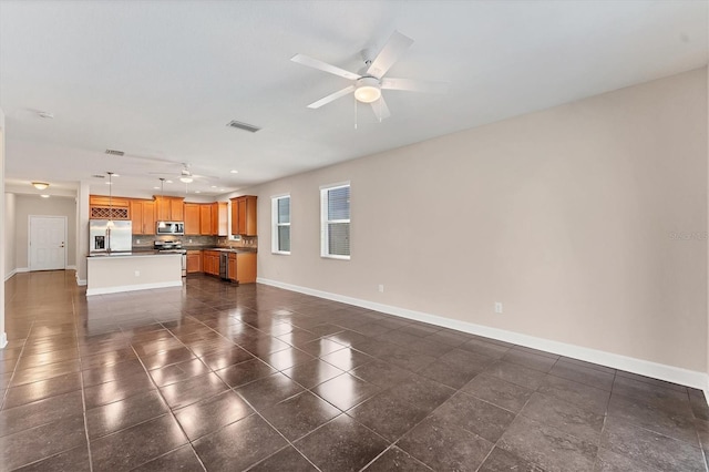 unfurnished living room featuring ceiling fan