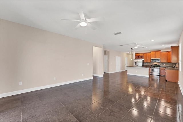 unfurnished living room featuring sink and ceiling fan