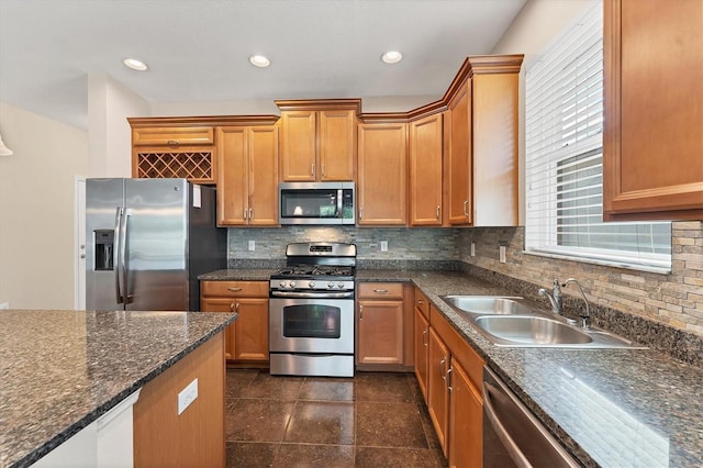 kitchen featuring stainless steel appliances, sink, and backsplash