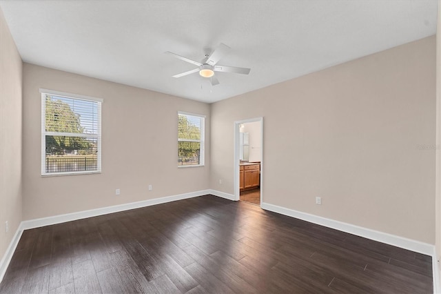 empty room with dark hardwood / wood-style floors and ceiling fan