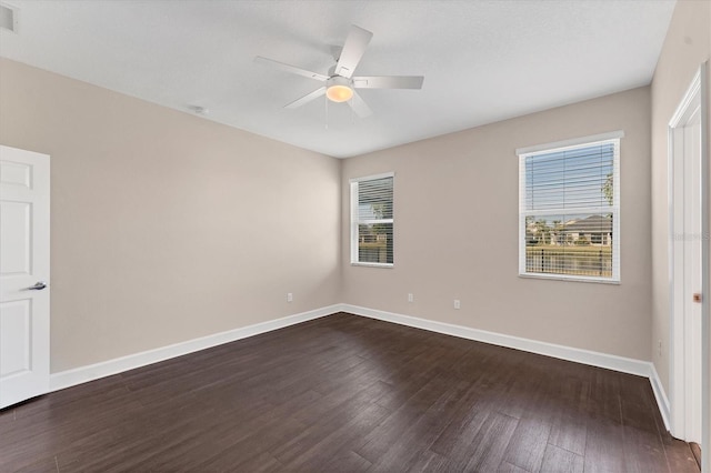 empty room featuring ceiling fan and dark hardwood / wood-style flooring