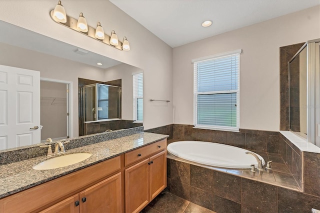 bathroom featuring vanity, independent shower and bath, and tile patterned flooring