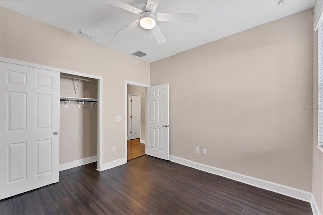 unfurnished bedroom featuring a closet, dark hardwood / wood-style floors, and ceiling fan