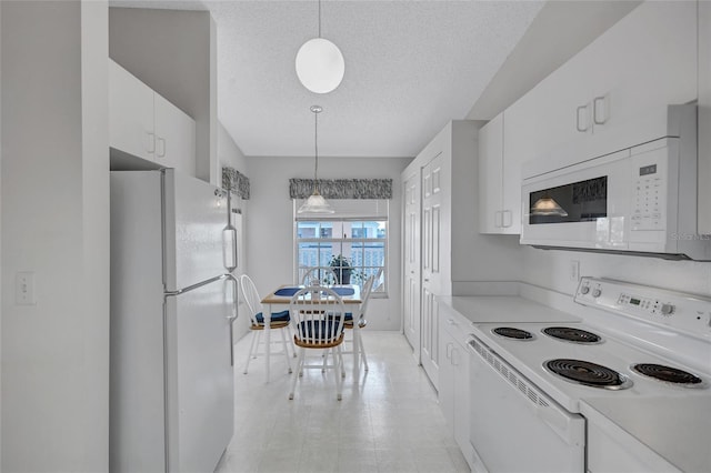 kitchen featuring white cabinetry, a textured ceiling, white appliances, and decorative light fixtures