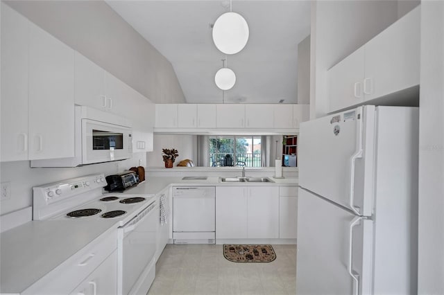 kitchen featuring white appliances, decorative light fixtures, and white cabinets