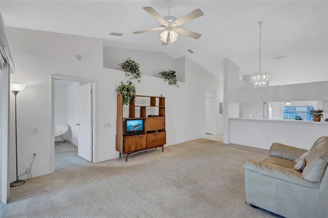 living room with ceiling fan with notable chandelier, light carpet, and high vaulted ceiling